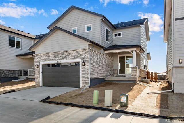 view of front of home with stone siding and concrete driveway