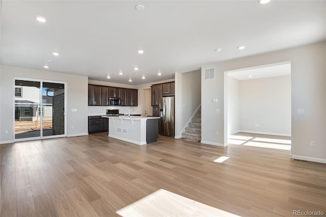 kitchen featuring visible vents, appliances with stainless steel finishes, open floor plan, light countertops, and light wood-type flooring