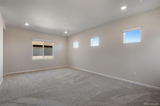 spare room with carpet, baseboards, and recessed lighting