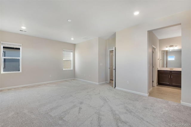 unfurnished bedroom featuring recessed lighting, baseboards, visible vents, and light colored carpet