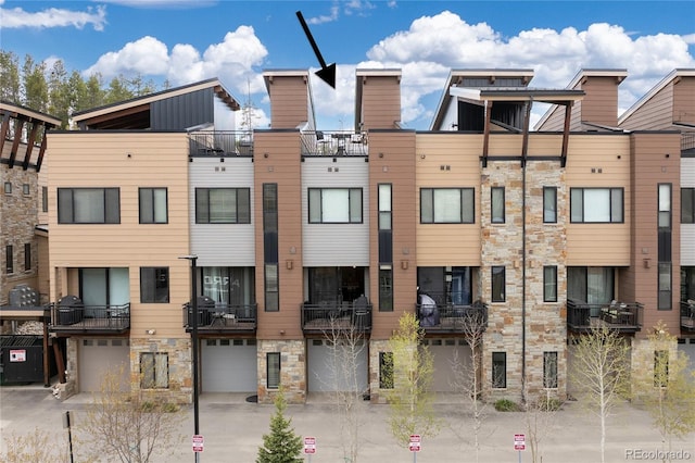 288 Lions Gate Dr, Winter Park, CO 80482 - view of building exterior with an attached garage and driveway