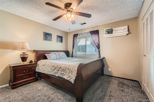 carpeted bedroom featuring ceiling fan, a closet, and a textured ceiling