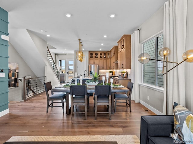 1787 W 166th Ave, Broomfield, CO 80023 - dining area with stairway, light wood-style flooring, a chandelier, and recessed lighting