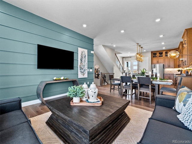 1787 W 166th Ave, Broomfield, CO 80023 - living area featuring stairs, wood finished floors, recessed lighting, and a chandelier