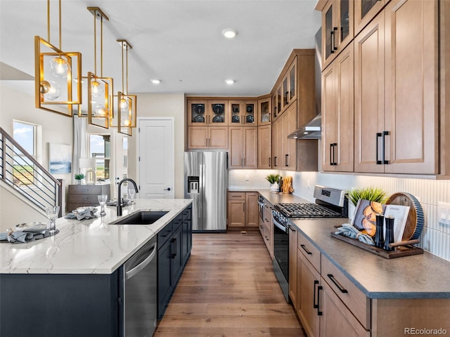 1787 W 166th Ave, Broomfield, CO 80023 - kitchen featuring appliances with stainless steel finishes, a center island with sink, light wood-style floors, recessed lighting, and decorative backsplash