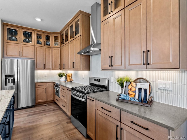 1787 W 166th Ave, Broomfield, CO 80023 - kitchen featuring stainless steel appliances, wall chimney range hood, tasteful backsplash, light wood-style floors, and light stone countertops