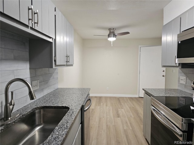 16259 W 10th Ave Unit K-3, Golden, CO 80401 - kitchen with appliances with stainless steel finishes, ceiling fan, light wood finished floors, and tasteful backsplash