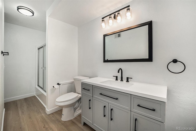 16259 W 10th Ave Unit K-3, Golden, CO 80401 - bathroom with wood finished floors, vanity, and combined bath / shower with glass door