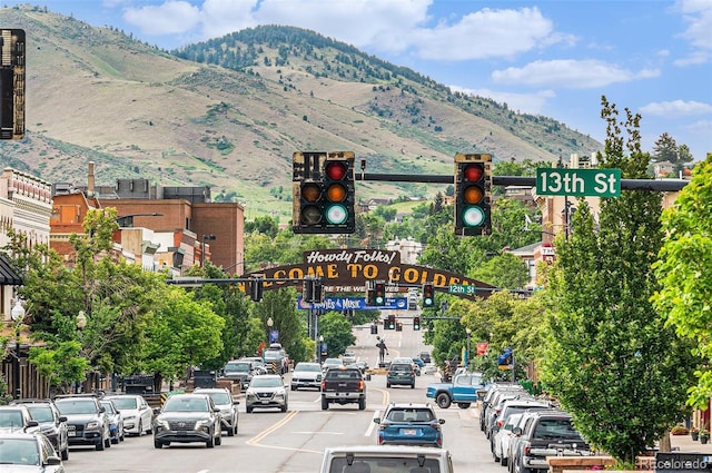 16259 W 10th Ave Unit K-3, Golden, CO 80401 - view of asphalt street with traffic lights, street lighting, a mountain view, and traffic signs