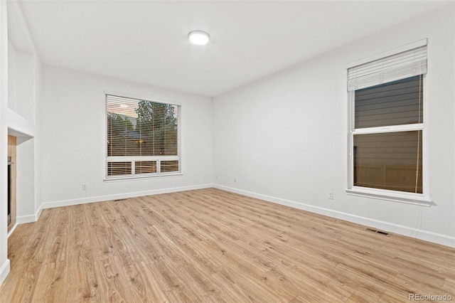 unfurnished living room with light hardwood / wood-style flooring