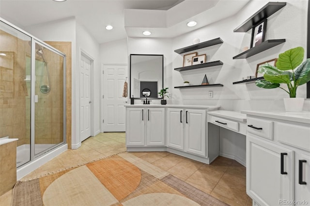 bathroom featuring tile patterned floors, vanity, and a shower with shower door