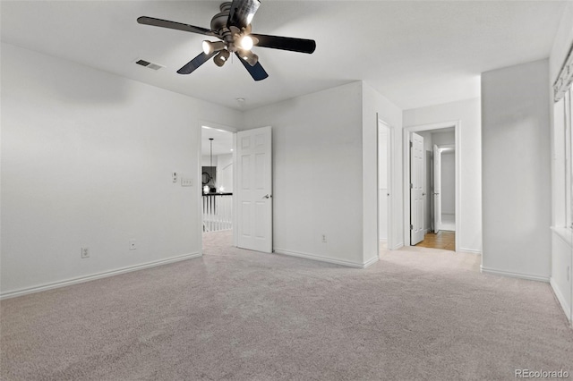 unfurnished bedroom with ceiling fan and light colored carpet