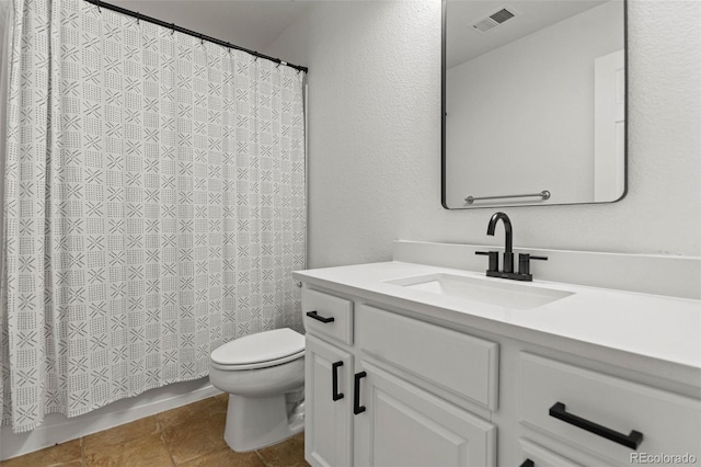 bathroom with tile patterned floors, vanity, and toilet