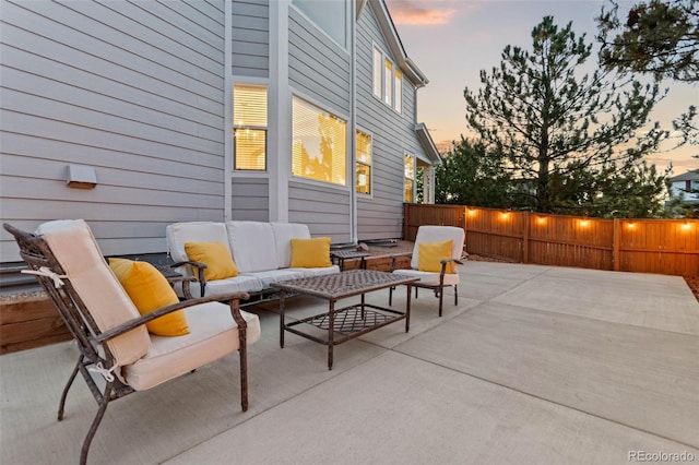 patio terrace at dusk featuring an outdoor living space