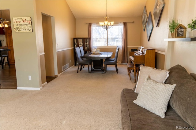 carpeted dining space with lofted ceiling and a notable chandelier