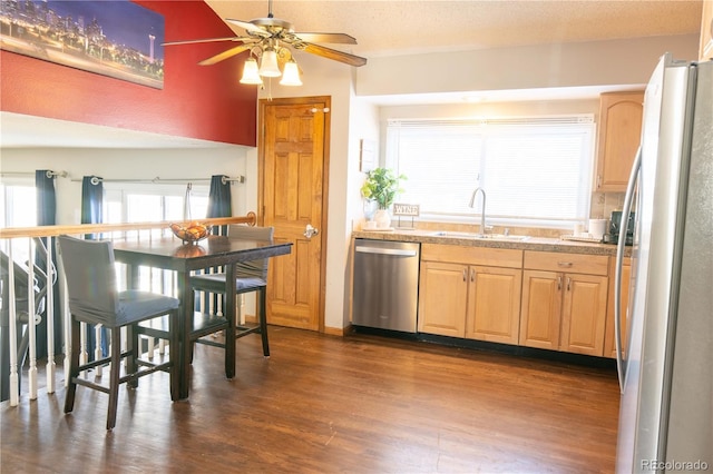 kitchen featuring appliances with stainless steel finishes, sink, dark hardwood / wood-style flooring, ceiling fan, and a textured ceiling