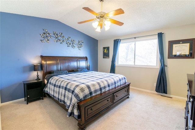 bedroom featuring ceiling fan, vaulted ceiling, and light carpet