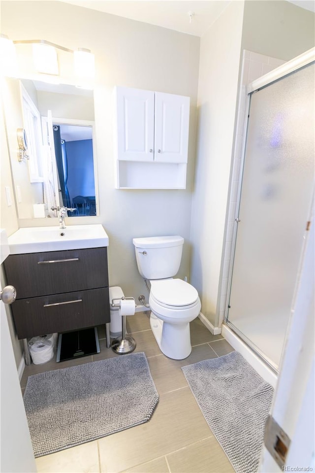 bathroom with vanity, toilet, and an enclosed shower