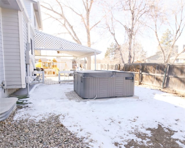 snowy yard with a hot tub