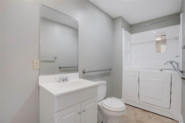 bathroom featuring vanity, toilet, and walk in shower