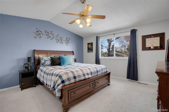 bedroom featuring lofted ceiling, baseboards, a textured ceiling, and light colored carpet