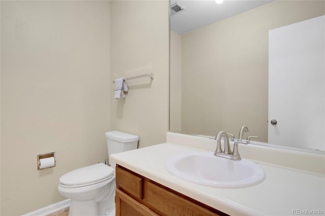 bathroom with visible vents, vanity, and toilet