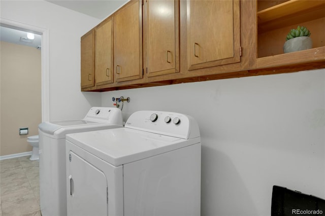 clothes washing area with baseboards and washing machine and clothes dryer