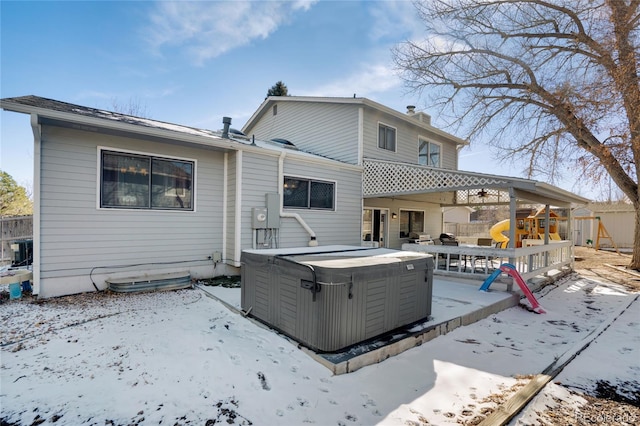 back of house with a chimney, fence, a hot tub, and central AC unit