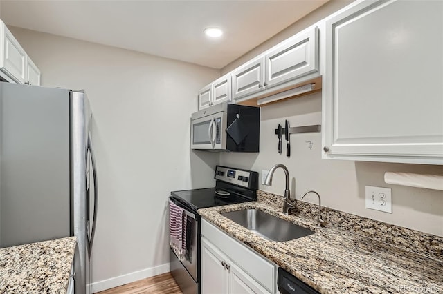 kitchen with white cabinets, sink, and appliances with stainless steel finishes