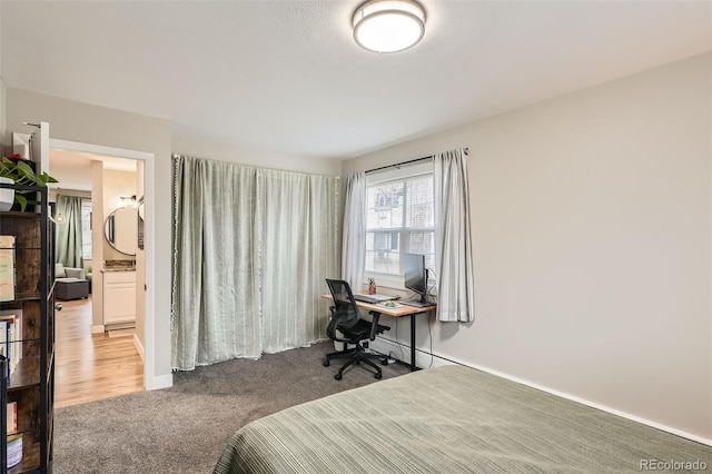 carpeted bedroom featuring ensuite bath