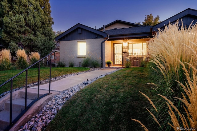 view of front facade featuring a front lawn and brick siding