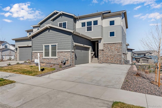 view of front of home featuring an attached garage, stone siding, and driveway