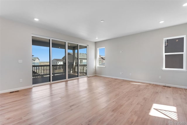unfurnished room featuring baseboards, recessed lighting, light wood-style flooring, and visible vents