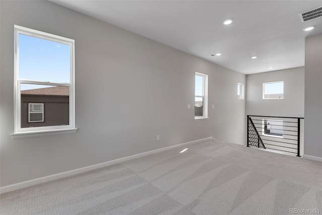 unfurnished room featuring carpet, baseboards, visible vents, and recessed lighting