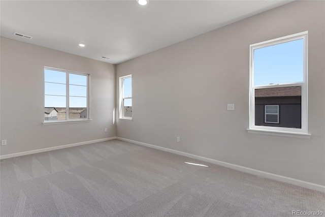 spare room with carpet flooring, visible vents, baseboards, and recessed lighting