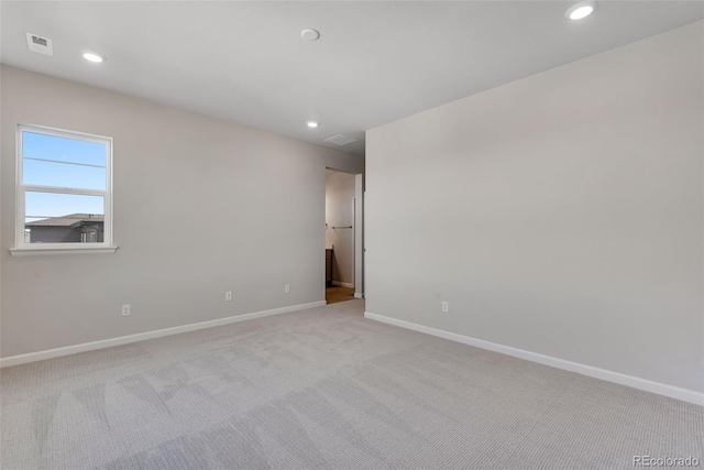 unfurnished room with light colored carpet, visible vents, baseboards, and recessed lighting