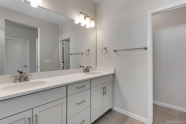 bathroom with tile patterned floors, double vanity, and a sink