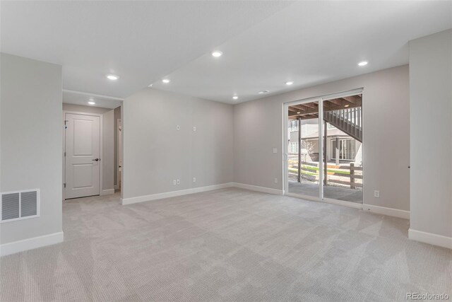 spare room with baseboards, recessed lighting, visible vents, and light colored carpet