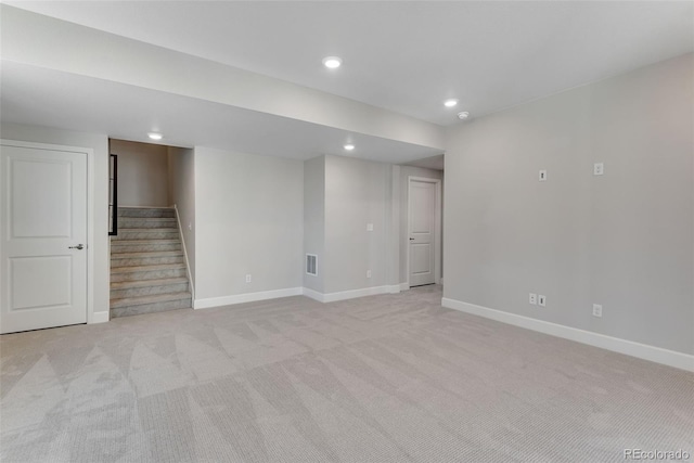 finished basement with baseboards, light carpet, recessed lighting, and stairway