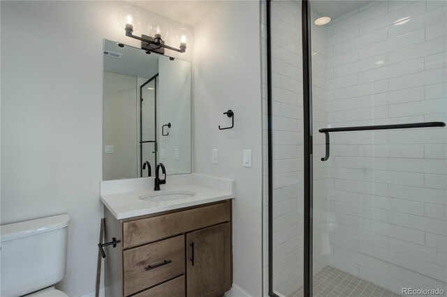 bathroom with vanity, toilet, and an enclosed shower