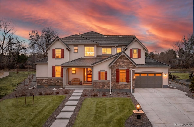 modern inspired farmhouse with stone siding, a lawn, driveway, and stucco siding