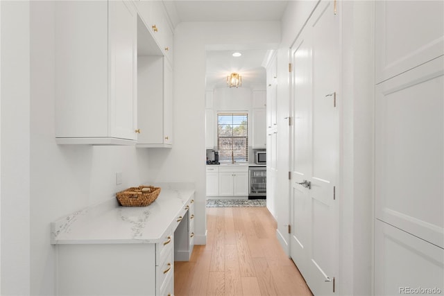 hall with light wood-style floors and beverage cooler