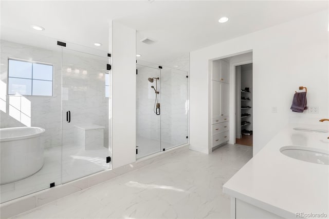 bathroom with marble finish floor, a sink, and a marble finish shower