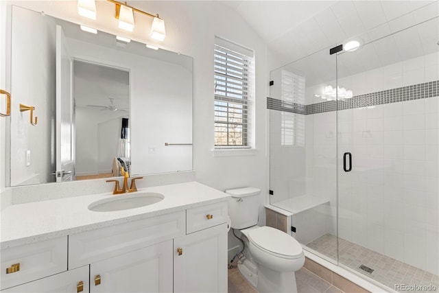 full bath with lofted ceiling, toilet, ceiling fan with notable chandelier, vanity, and a stall shower