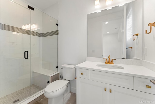 bathroom with a shower stall, toilet, and vanity