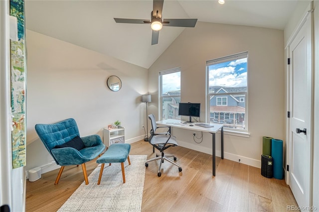 office space featuring ceiling fan, lofted ceiling, and light hardwood / wood-style floors