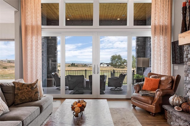 entryway with plenty of natural light, wood ceiling, and light wood-type flooring