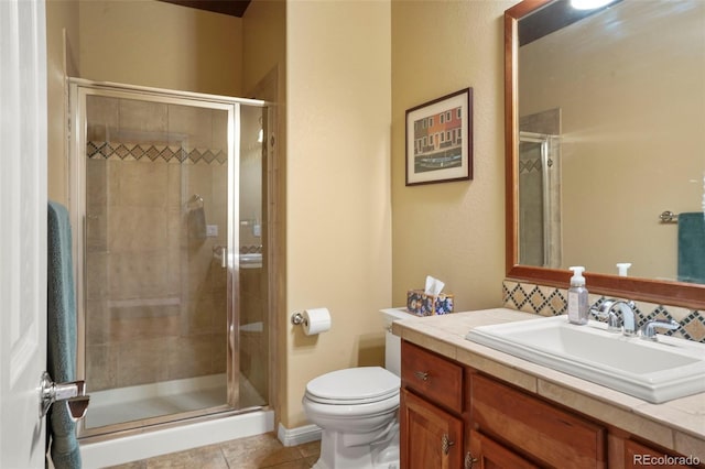 bathroom featuring walk in shower, vanity, toilet, and tile patterned flooring