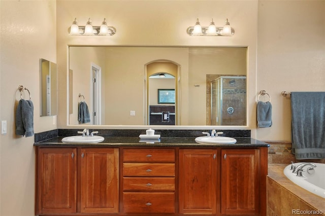 bathroom with vanity and shower with separate bathtub