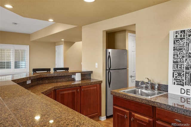 kitchen with sink, light tile patterned floors, and stainless steel fridge